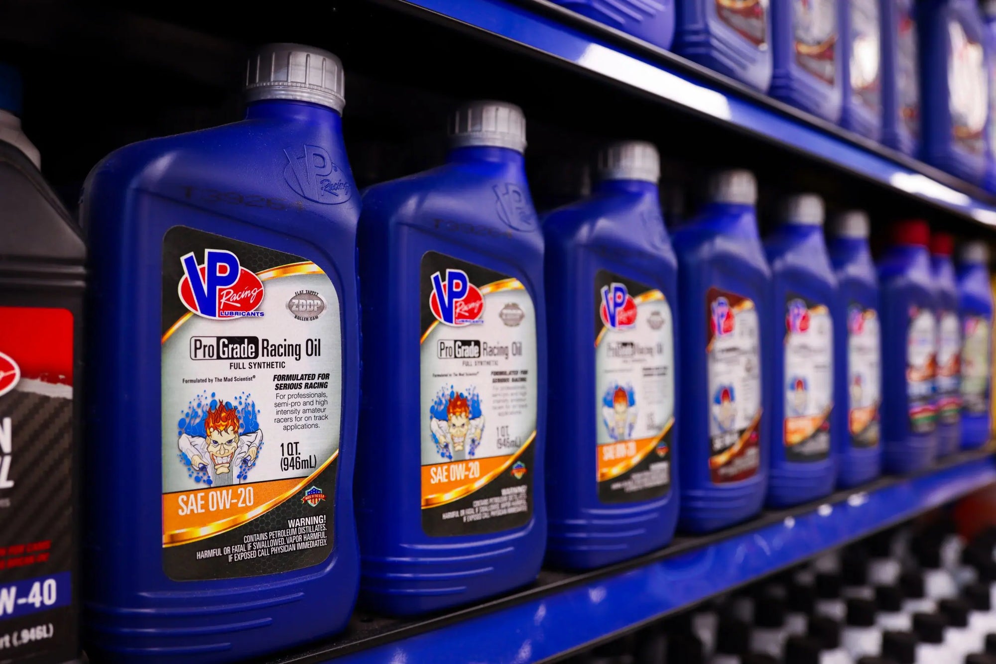 hero image for article discussing Synthetic Oil vs. Conventional Oil vs. Synthetic Blend oils. Image shows multiple bottles of VP Pro Grade Full Synthetic engine oil on a shelf in a retail store
