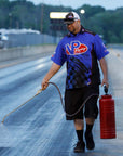 image of a race track employee spraying VP Lane Choice 7 traction compound on a track