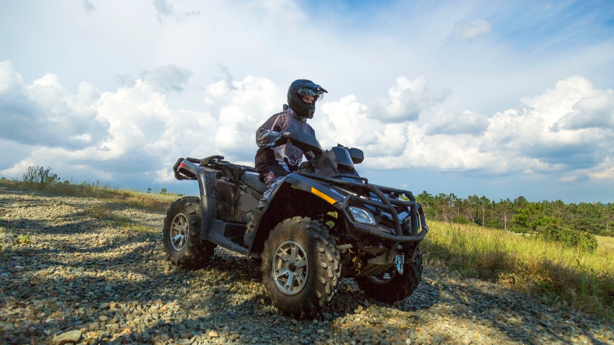 ATV rider navigating a rocky trail