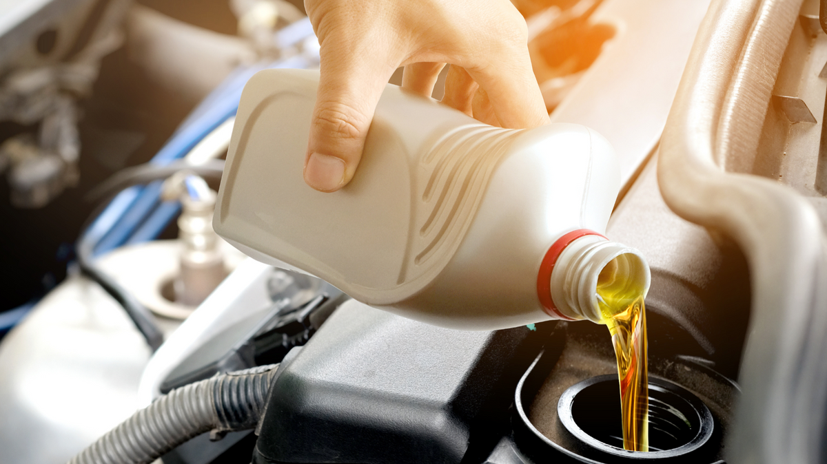 Motorcycle oil being poured into an engine