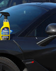 lifestyle image of a bottle of VP Racing's instant detailer spray sitting on the hood of a car near the windshield