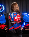 Female wearing a VP Winners Circle Jacket with her back facing the camera to show off a large VP Racing logo on the back of the jacket