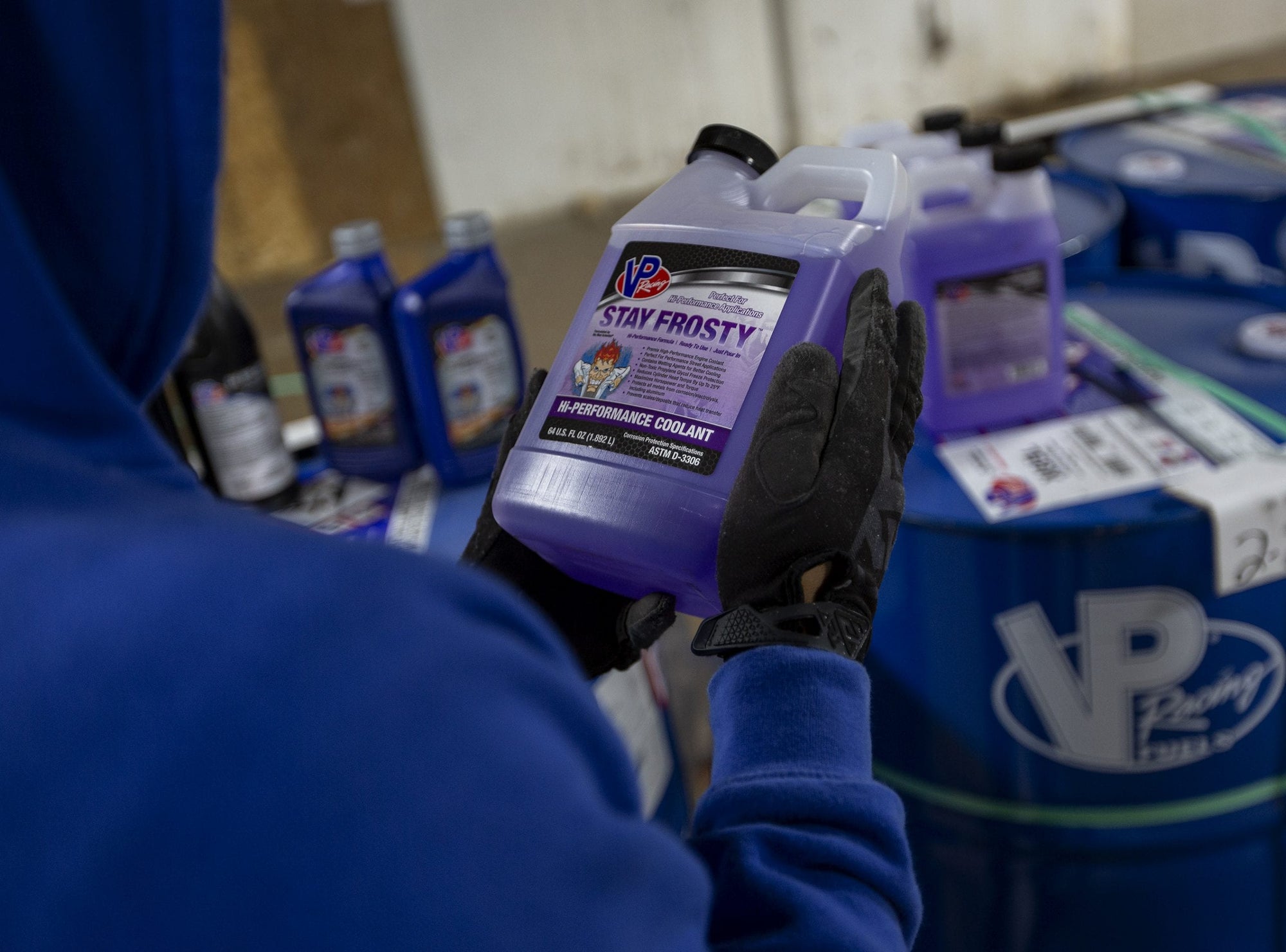 Lifestyle image showing a man holding a bottle of Stay Frosty Hi-Performance Stay Frosty Hi-Performance Propylene Glycol Coolant