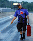 image of a man in a VP Racing shirt spraying VP Starting Line Resin on a race track