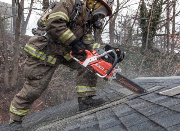firefighter using a chainsaw