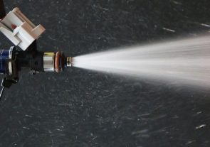 does fuel injector cleaner work? Picture of clean fuel injector spraying fuel