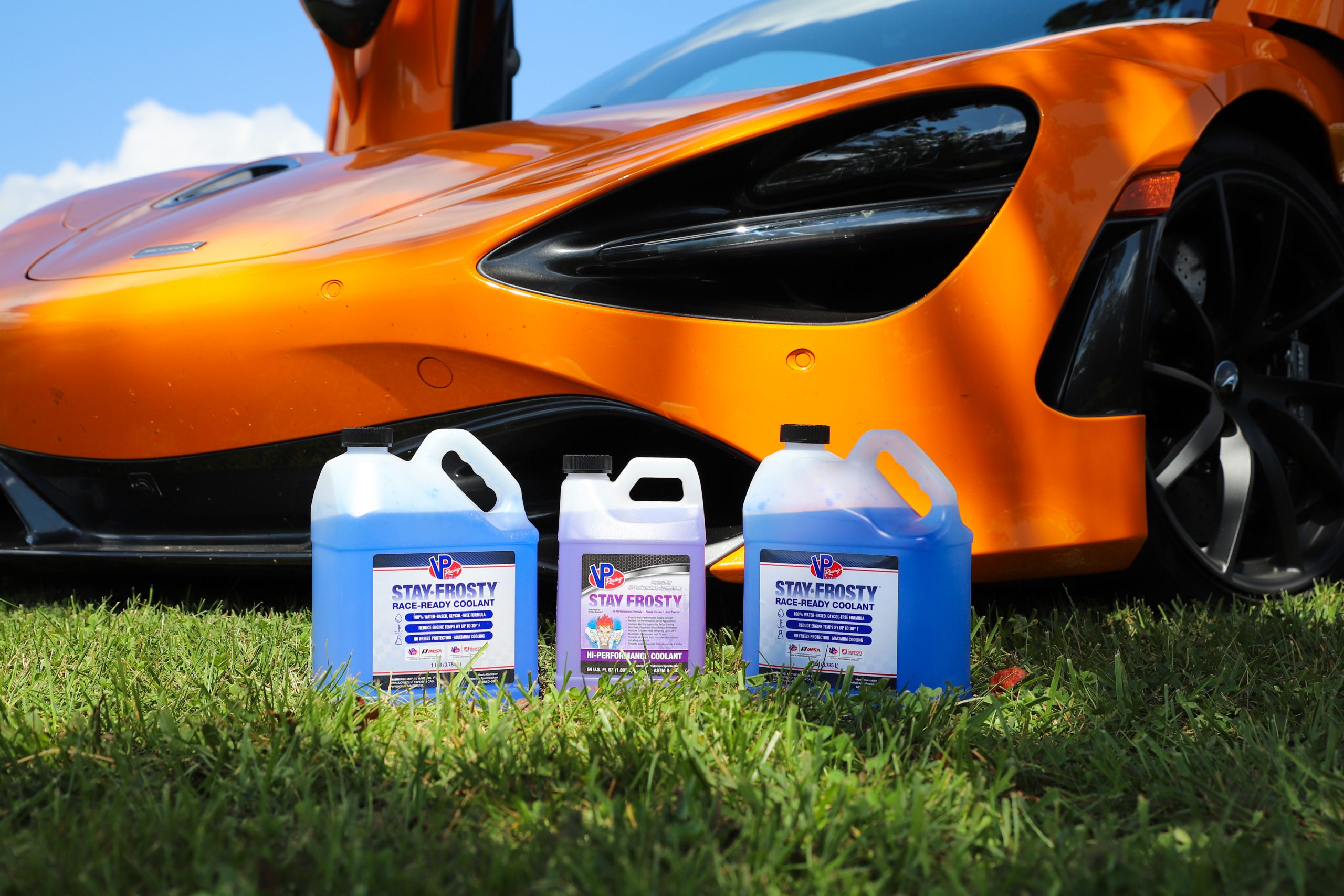 two bottles of VP Stay Frosty Race-Ready racing engine coolant and one bottle of stay frosty hi-performance engine coolant pictured in front of a sports car. Stay Frosty controls engine heat, which is factor that can have an effect on your vehicle engine control unit. It's 3 wetting agents and 100% reverse osmosis water formulation make it the best engine coolant for race cars and high-performance vehicles