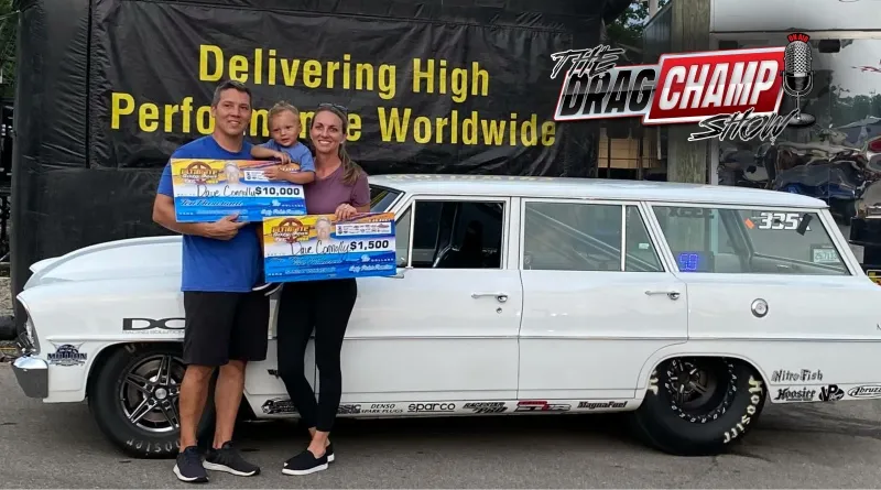 Dave Connolly, KB Racing crew chief, shows off a winners check with his family while standing in front of his dragster wagon