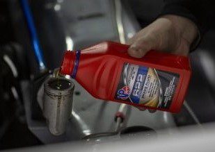 vp racing 622 brake fluid being poured into a reservoir