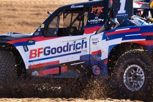 rob maccachren racing in the desert in his BF Goodrich Tropy Truck. Closeup shot showing side of truck from the driver's side