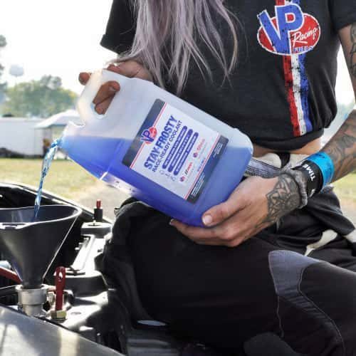 64 ounce bottle of Stay Frosty Race-Ready engine coolant being poured into a radiator