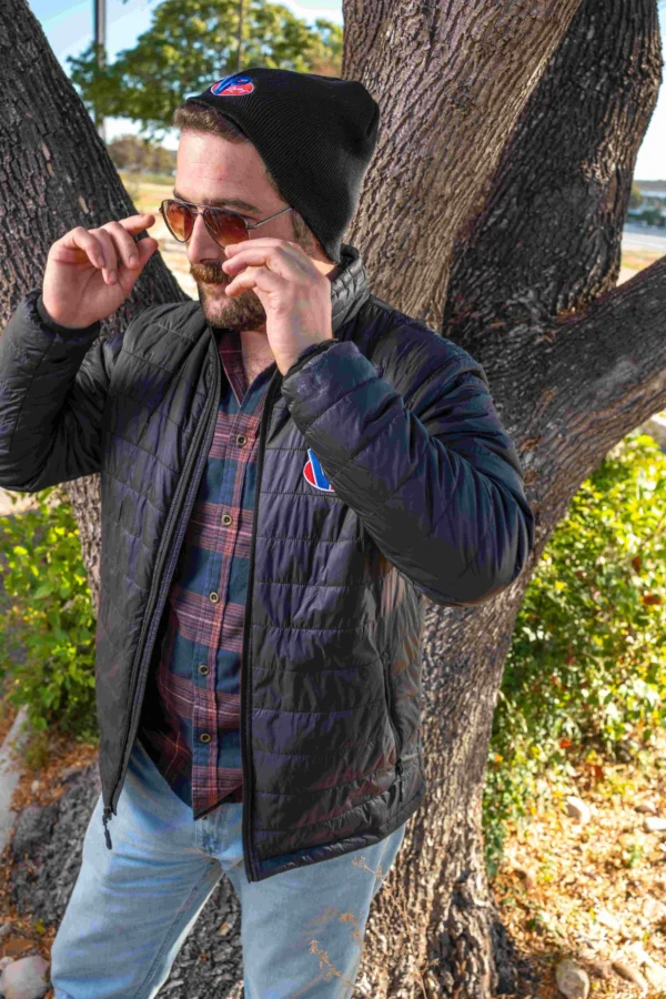 Lifestyle image of male model putting on sunglasses while wearing the VP Turbo Jacket.